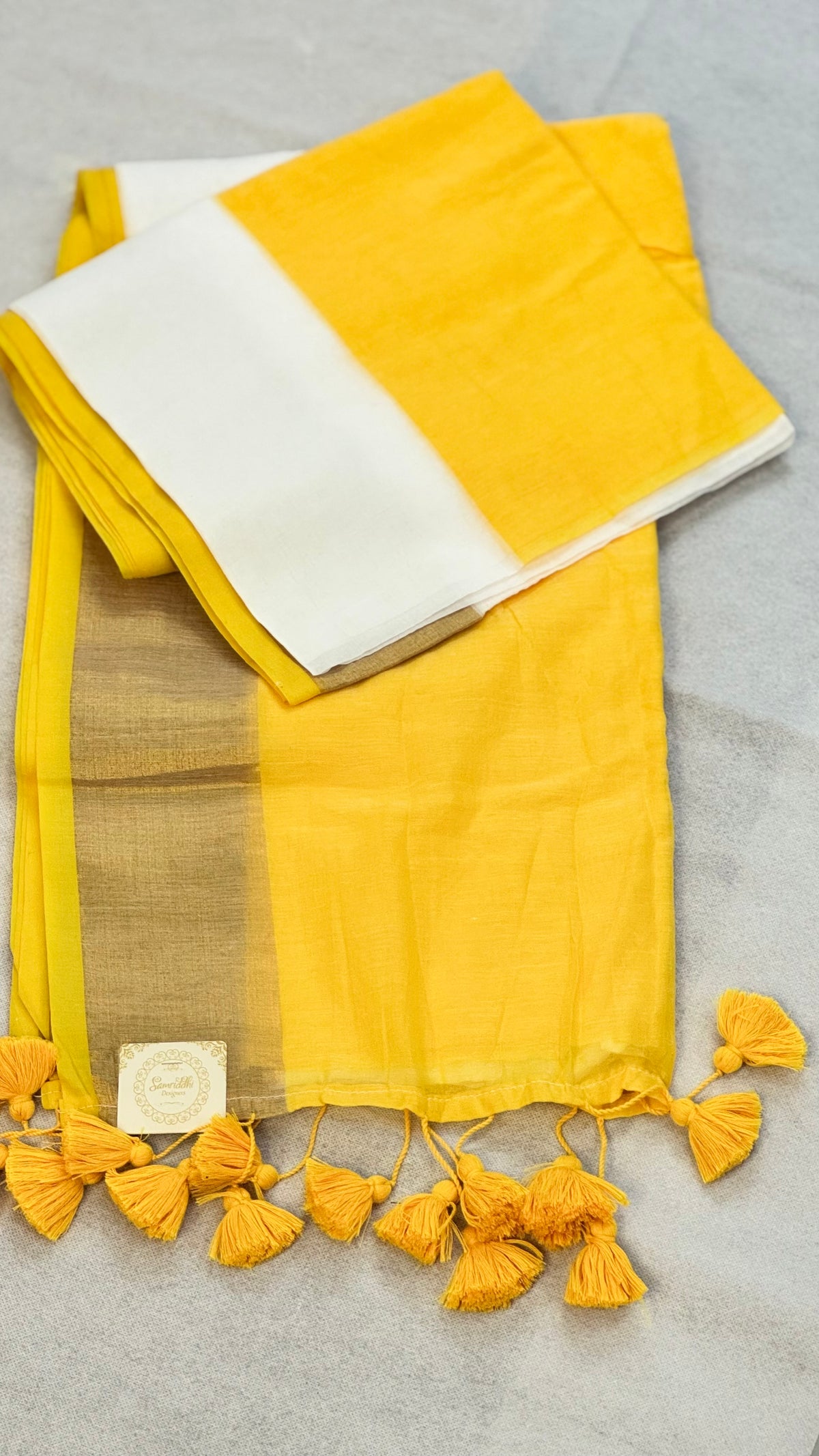 Surya Rekha-Yellow & White Mul Cotton saree with zari border tassels